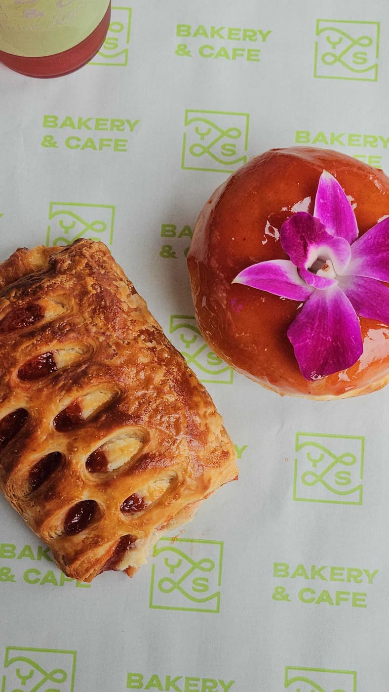 Branded pastry bag and donut at YLS Bakery & Cafe